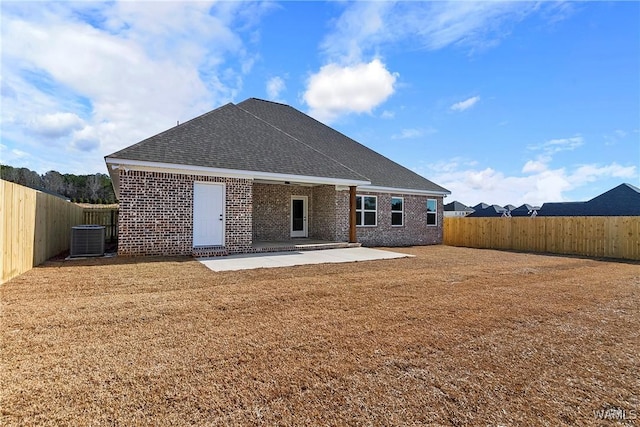 back of property featuring a patio, a yard, and central AC unit