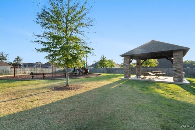 view of community with a yard, a gazebo, and a patio area