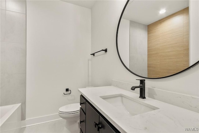 bathroom featuring tile patterned floors, toilet, a bath, and vanity