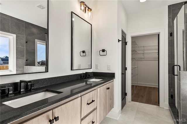 13990 Glen Park Ave, Northport, AL 35476 - bathroom featuring a shower with door, vanity, and tile patterned floors