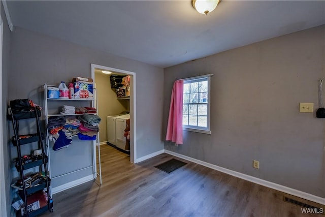 interior space featuring wood-type flooring and washer and clothes dryer