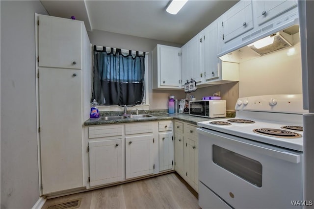 kitchen featuring white cabinetry, sink, white appliances, and light hardwood / wood-style floors