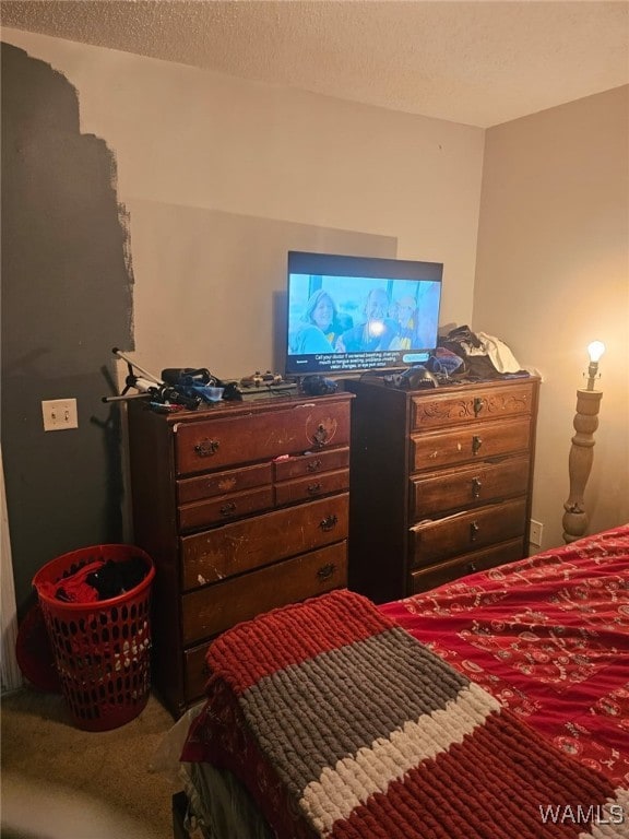 bedroom with a textured ceiling and carpet