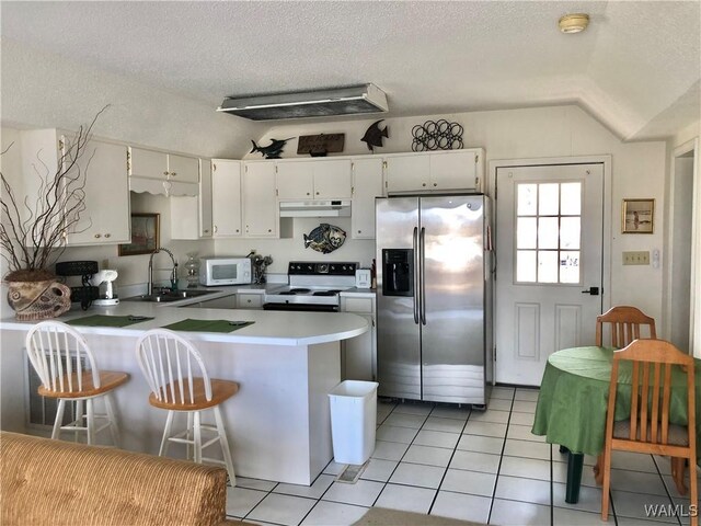 2230 Oak Village Rd, Akron, AL 35441 - kitchen with white microwave, a peninsula, electric range, stainless steel fridge, and a sink
