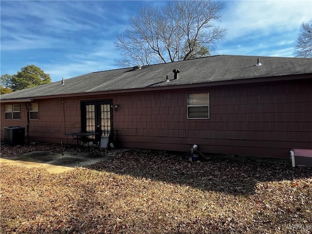 rear view of property featuring central AC unit and a patio area