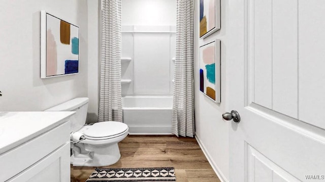 full bathroom with shower / bath combo, vanity, hardwood / wood-style flooring, and toilet