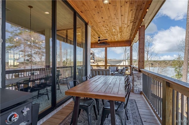 wooden terrace with outdoor dining area
