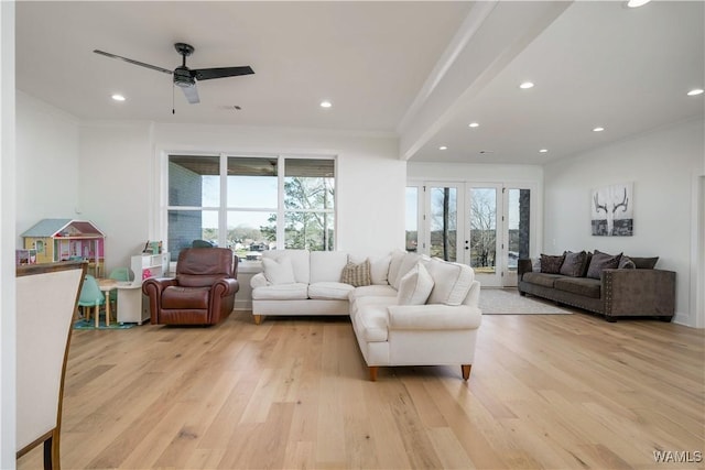 living room with recessed lighting, crown molding, and light wood-style floors