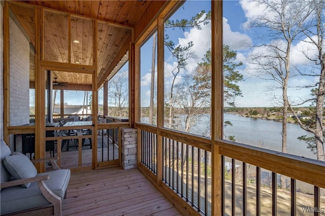 unfurnished sunroom featuring a water view