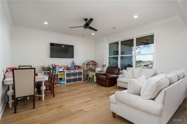 living room featuring visible vents, ceiling fan, light wood-type flooring, ornamental molding, and recessed lighting