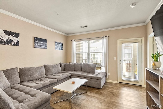 living room with hardwood / wood-style flooring and ornamental molding