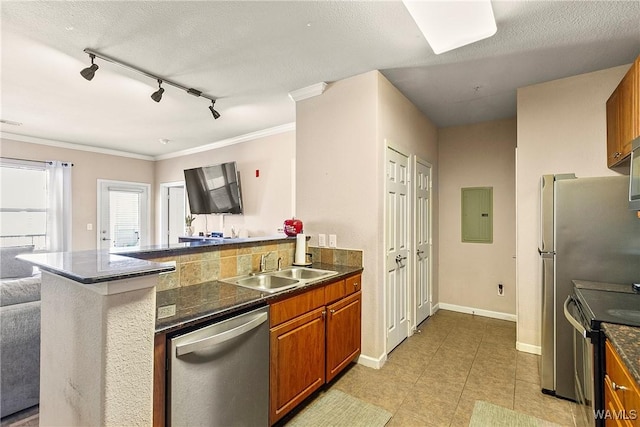 kitchen featuring sink, appliances with stainless steel finishes, electric panel, a textured ceiling, and kitchen peninsula