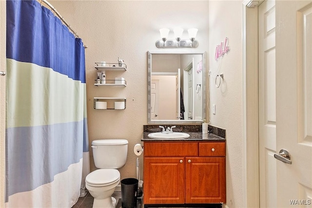 bathroom featuring vanity, a shower with curtain, and toilet