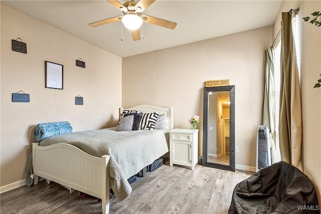 bedroom with ceiling fan and light hardwood / wood-style flooring