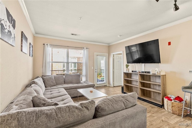 living room featuring light hardwood / wood-style flooring and ornamental molding