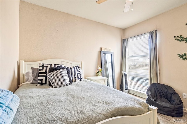 bedroom featuring hardwood / wood-style flooring and ceiling fan