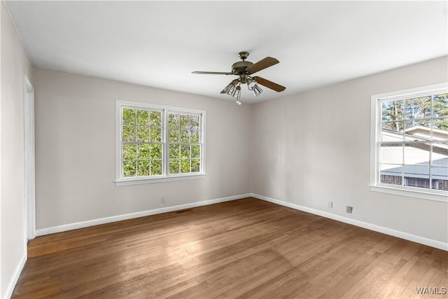 unfurnished room featuring dark wood-type flooring and ceiling fan