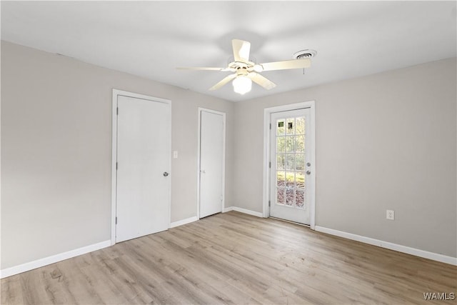 spare room with ceiling fan and light hardwood / wood-style flooring