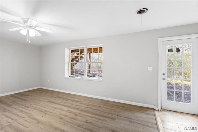 unfurnished room featuring plenty of natural light, ceiling fan, and light hardwood / wood-style flooring