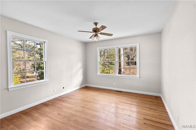 unfurnished room with ceiling fan and light wood-type flooring