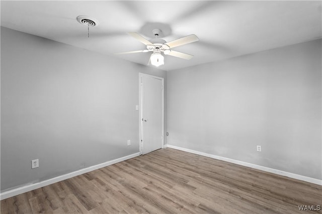 spare room featuring ceiling fan and light wood-type flooring