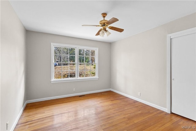 empty room with light hardwood / wood-style floors and ceiling fan