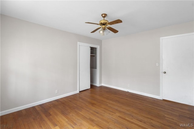 unfurnished bedroom with hardwood / wood-style flooring, ceiling fan, and a closet