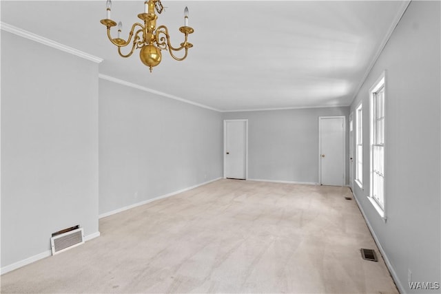 carpeted empty room with crown molding and a chandelier