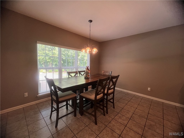 tiled dining area with a chandelier