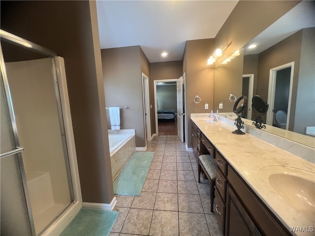 bathroom with plus walk in shower, vanity, and tile patterned floors