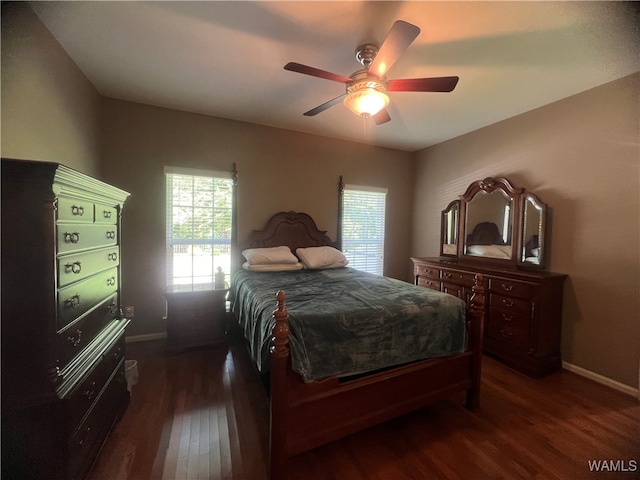 bedroom with ceiling fan and dark hardwood / wood-style flooring