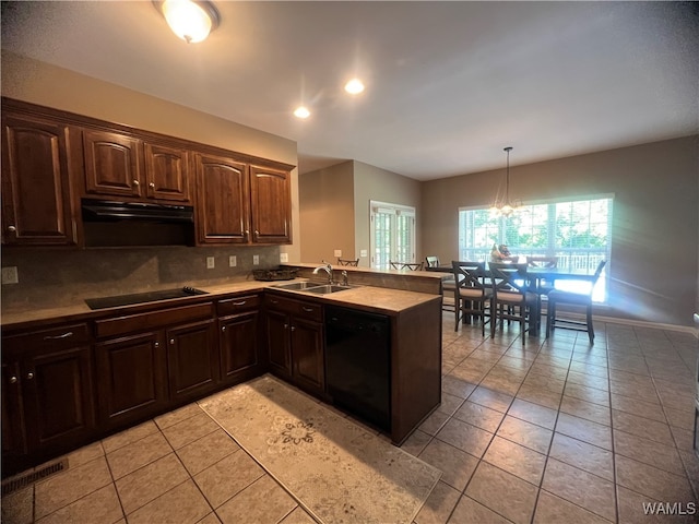 kitchen featuring a notable chandelier, black appliances, tasteful backsplash, decorative light fixtures, and kitchen peninsula