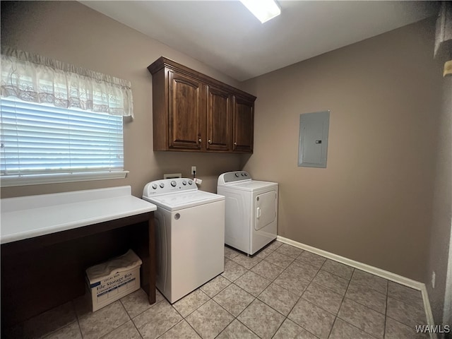 laundry room featuring washer and clothes dryer, cabinets, light tile patterned floors, and electric panel