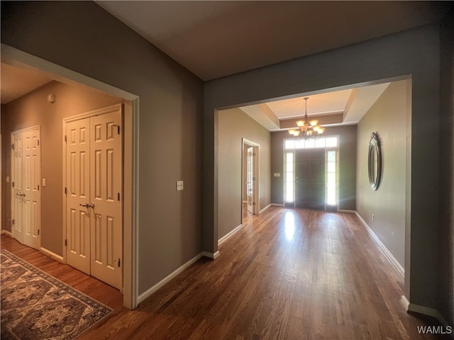 hallway featuring a chandelier and dark hardwood / wood-style flooring