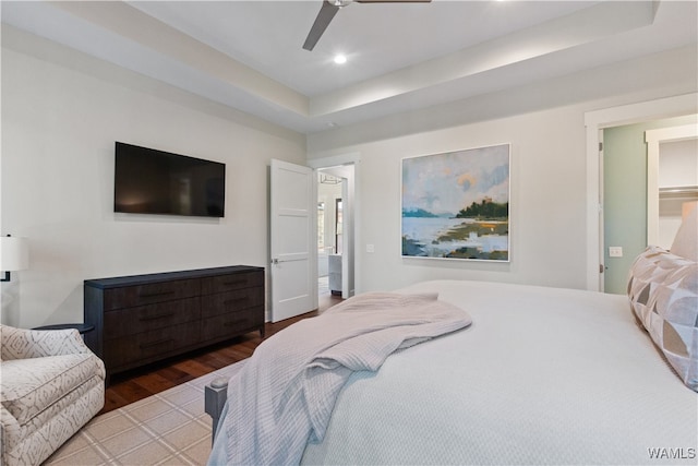 12437 Rising Tide, Northport, AL 35475 - bedroom featuring hardwood / wood-style flooring, ceiling fan, connected bathroom, and a tray ceiling