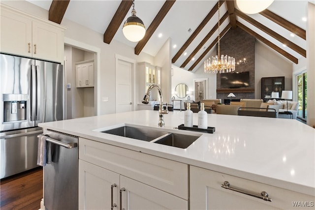 12437 Rising Tide, Northport, AL 35475 - kitchen featuring sink, dark hardwood / wood-style floors, beamed ceiling, white cabinetry, and stainless steel appliances