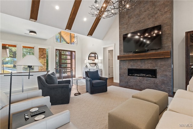 12437 Rising Tide, Northport, AL 35475 - living room with high vaulted ceiling, beamed ceiling, a notable chandelier, hardwood / wood-style floors, and a fireplace