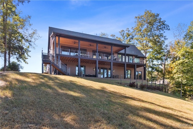 12437 Rising Tide, Northport, AL 35475 - rear view of house featuring a lawn, ceiling fan, and a balcony