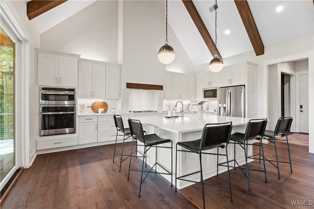 12437 Rising Tide, Northport, AL 35475 - kitchen with white cabinetry, beamed ceiling, and stainless steel appliances