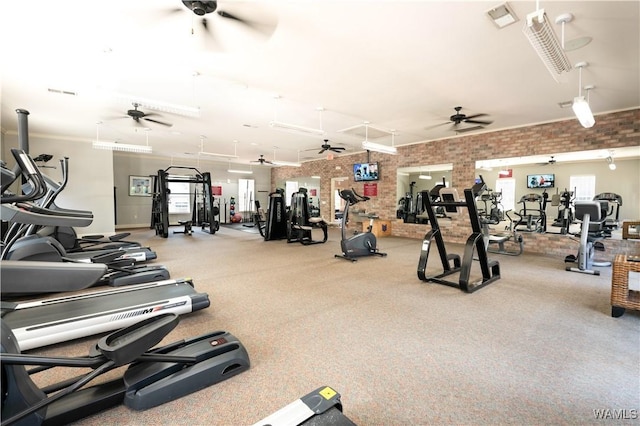 workout area featuring brick wall, plenty of natural light, visible vents, and a ceiling fan