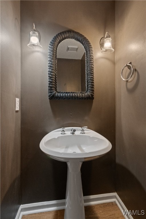 bathroom with wood-type flooring