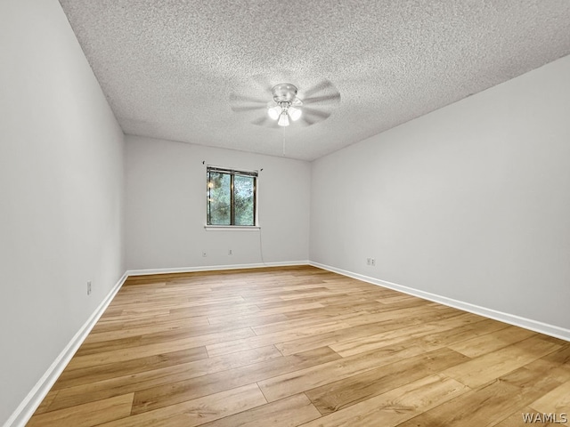 unfurnished room featuring light hardwood / wood-style floors and a textured ceiling