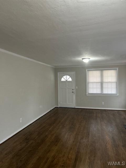 entryway featuring a textured ceiling, ornamental molding, and dark wood-type flooring