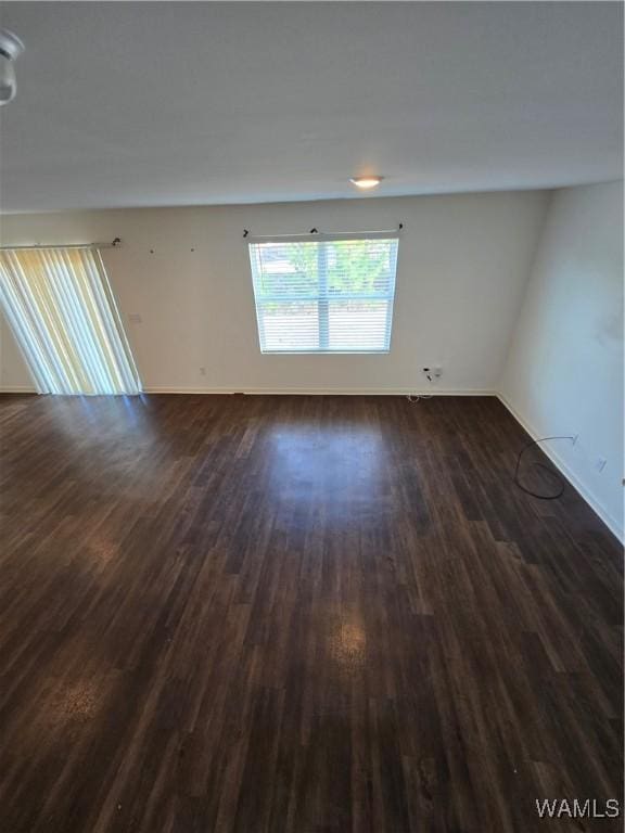 unfurnished room with dark hardwood / wood-style floors