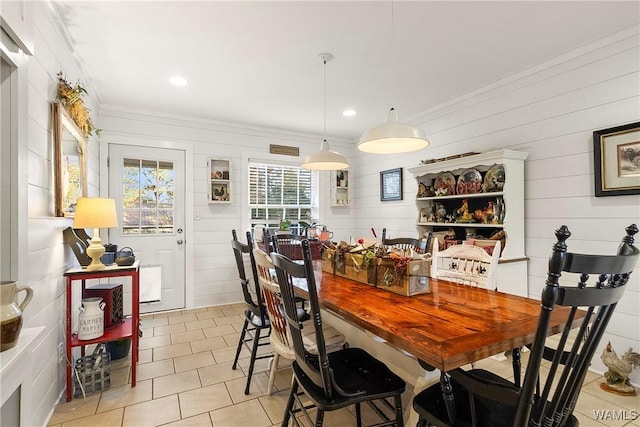 dining area featuring wooden walls