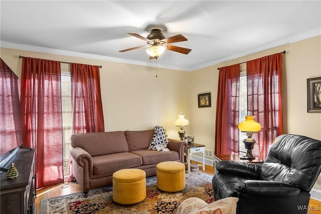 living room featuring crown molding, ceiling fan, and wood-type flooring