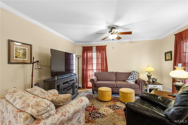 living room featuring crown molding, ceiling fan, and hardwood / wood-style flooring