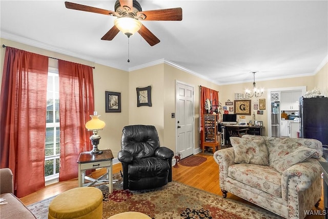 living room featuring ceiling fan with notable chandelier, a healthy amount of sunlight, crown molding, and light hardwood / wood-style flooring