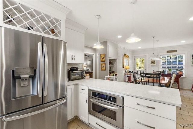 kitchen featuring white cabinets, appliances with stainless steel finishes, and kitchen peninsula