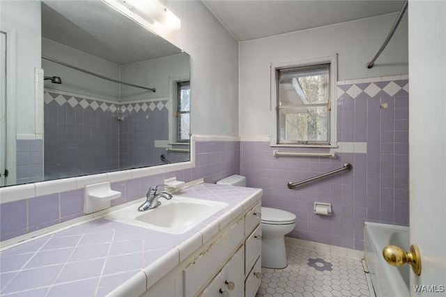 full bathroom featuring tile patterned flooring, vanity, toilet, and a healthy amount of sunlight